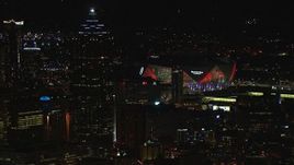 HD stock footage aerial video of Mercedes Benz Stadium while flying by skyscraper at night, Downtown Atlanta, Georgia Aerial Stock Footage | CAP_013_004