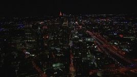 HD stock footage aerial video flying away from city buildings and skyscrapers at night, Midtown Atlanta, Georgia Aerial Stock Footage | CAP_013_019