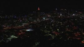 HD stock footage aerial video of flying past city buildings and skyscrapers at night, Midtown and Downtown Atlanta, Georgia Aerial Stock Footage | CAP_013_023