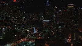 HD stock footage aerial video of flying away from city buildings and skyscrapers near Ferris wheel at night, Downtown Atlanta, Georgia Aerial Stock Footage | CAP_013_028
