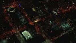 HD stock footage aerial video reverse view of rooftop hotel pool and street at night, Midtown Atlanta, Georgia Aerial Stock Footage | CAP_013_040