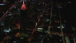 HD stock footage aerial video reverse view of streets by Bank of America Plaza at night, Midtown Atlanta, Georgia Aerial Stock Footage | CAP_013_041