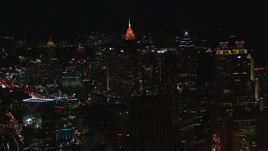 HD stock footage aerial video reverse view of Midtown and downtown skyscrapers at night, Downtown and Midtown Atlanta, Georgia Aerial Stock Footage | CAP_013_044