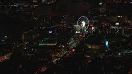 HD stock footage aerial video of a condo complex and Ferris wheel at nighttime, Downtown Atlanta, Georgia Aerial Stock Footage | CAP_013_058