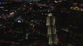 HD stock footage aerial video of a Ferris wheel at nighttime while passing a skyscraper, Downtown Atlanta, Georgia Aerial Stock Footage | CAP_013_065
