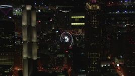 HD stock footage aerial video of flying by skyscrapers to reveal the Ferris wheel at night, Downtown Atlanta, Georgia Aerial Stock Footage | CAP_013_099