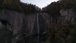 2.7K stock footage aerial video approach a clifftop waterfall at sunset, Chimney Rock, North Carolina Aerial Stock Footage | CAP_014_013