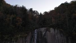 2.7K stock footage aerial video ascend over a clifftop waterfall at sunset, Chimney Rock, North Carolina Aerial Stock Footage | CAP_014_014