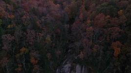 2.7K stock footage aerial video a reverse view of forest, reveal a clifftop waterfall at sunset, Chimney Rock, North Carolina Aerial Stock Footage | CAP_014_018