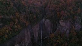 2.7K stock footage aerial video a reverse view of forest and a clifftop waterfall at sunset, Chimney Rock, North Carolina Aerial Stock Footage | CAP_014_019