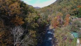 2.7K stock footage aerial video follow river surrounded by forest trees, Chimney Rock, North Carolina Aerial Stock Footage | CAP_014_028
