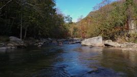 2.7K stock footage aerial video flying low over the river surrounded by forest trees, Chimney Rock, North Carolina Aerial Stock Footage | CAP_014_029