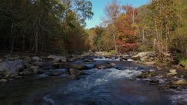 2.7K stock footage aerial video flying low over rocks and water in the river surrounded by forest trees, Chimney Rock, North Carolina Aerial Stock Footage | CAP_014_030