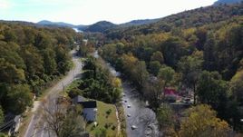 2.7K stock footage aerial video of flying over a river beside a road through a small town, Chimney Rock, North Carolina Aerial Stock Footage | CAP_014_032