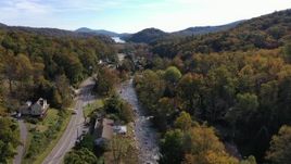 2.7K stock footage aerial video of flying over a river beside a road in a small town, Chimney Rock, North Carolina Aerial Stock Footage | CAP_014_033