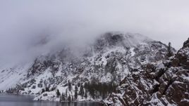 4K stock footage aerial video of panning across snowy mountain slopes beside lake in Inyo National Forest, California Aerial Stock Footage | CAP_015_002