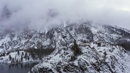 4K stock footage aerial video of flying by a snowy mountain in the Sierra Nevadas, Inyo National Forest, California Aerial Stock Footage | CAP_015_026