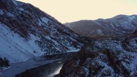 4K stock footage aerial video ascend with view of snowy Sierra Nevada Mountains by lake at sunset, Inyo National Forest, California Aerial Stock Footage | CAP_015_029