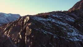 4K stock footage aerial video ascend by rocky slope with snow at sunset, Inyo National Forest, California Aerial Stock Footage | CAP_015_031