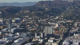 HD stock footage aerial video orbit apartment buildings and college, reveal the Hollywood Sign Hollywood, California Aerial Stock Footage | CAP_016_010