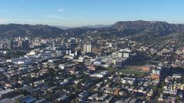 HD stock footage aerial video of flying away from Hollywood Sign and office buildings, California Aerial Stock Footage | CAP_016_026
