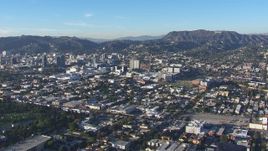 HD stock footage aerial video of a reverse view of Hollywood Sign and office buildings, California Aerial Stock Footage | CAP_016_027