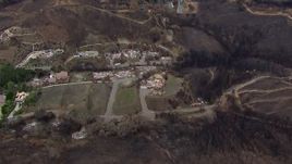 HD stock footage aerial video of approaching homes destroyed by fire, Malibu, California Aerial Stock Footage | CAP_018_020