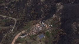 HD stock footage aerial video of orbiting a hillside home destroyed by fire, Malibu, California Aerial Stock Footage | CAP_018_024