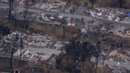 HD stock footage aerial video of a close-up view of a neighborhood destroyed by fire, Malibu, California Aerial Stock Footage | CAP_018_032