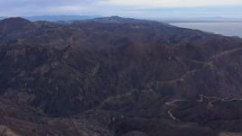 HD stock footage aerial video of flying by mountains devastated by fire, Malibu, California Aerial Stock Footage | CAP_018_038