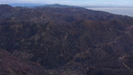 HD stock footage aerial video of flying over mountains scorched by fire, Malibu, California Aerial Stock Footage | CAP_018_039