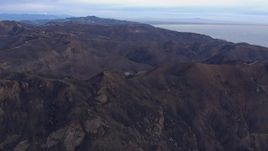 HD stock footage aerial video of approaching mountains scorched by fire, Malibu, California Aerial Stock Footage | CAP_018_040