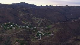 HD stock footage aerial video of mountains scorched by fire near hillside homes, Malibu, California Aerial Stock Footage | CAP_018_042