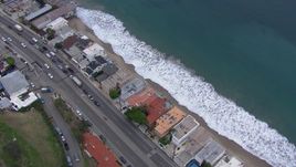 HD stock footage aerial video of tilting to a bird's eye view of beachfront homes by PCH at sunset, California Aerial Stock Footage | CAP_018_058
