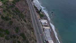 HD stock footage aerial video of following light traffic on PCH at sunset, flyby Malibu homes, California Aerial Stock Footage | CAP_018_060