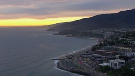 HD stock footage aerial video of a wide reverse view of Malibu at sunset, California Aerial Stock Footage | CAP_018_063