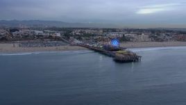 HD stock footage aerial video orbit the end of Santa Monica Pier and Ferris wheel at sunset, California Aerial Stock Footage | CAP_018_069