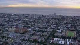 HD stock footage aerial video of a reverse view of Santa Monica and the ocean at sunset, California Aerial Stock Footage | CAP_018_074