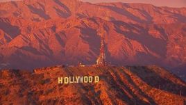 HD stock footage aerial video of flying away from the famous Hollywood Sign and radio towers at sunset, California Aerial Stock Footage | CAP_018_086