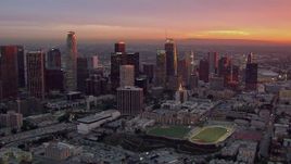 HD stock footage aerial video of passing by the Downtown Los Angeles skyline at sunset, California Aerial Stock Footage | CAP_018_090