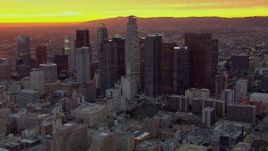 HD stock footage aerial video of flying away from and past the Downtown Los Angeles skyscrapers at sunset, California Aerial Stock Footage | CAP_018_093