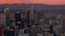 HD stock footage aerial video flying by towering Downtown Los Angeles skyscrapers at sunset, California Aerial Stock Footage | CAP_018_097