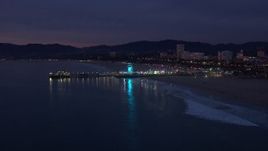 HD stock footage aerial video of approaching Santa Monica Pier and Ferris wheel at twilight, California Aerial Stock Footage | CAP_018_107