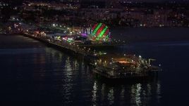 HD stock footage aerial video of flying toward the end of Santa Monica Pier and Ferris wheel at twilight, California Aerial Stock Footage | CAP_018_110