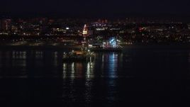 HD stock footage aerial video approach the Ferris wheel and rides at night, Santa Monica Pier, California Aerial Stock Footage | CAP_018_114
