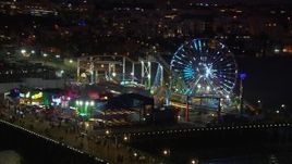 HD stock footage aerial video orbit the Ferris wheel and rides at night, Santa Monica Pier, California Aerial Stock Footage | CAP_018_116