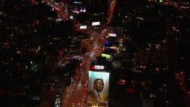 HD stock footage aerial video fly over billboard for view of traffic on the Sunset Strip at night in West Hollywood, California Aerial Stock Footage | CAP_018_127