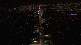 HD stock footage aerial video of tilting for a wide view of Sunset Blvd at night through Hollywood, California Aerial Stock Footage | CAP_018_135