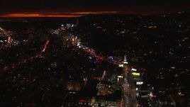 HD stock footage aerial video approach Sunset Strip and tilt to billboards and traffic at night in West Hollywood, California Aerial Stock Footage | CAP_018_137