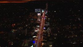 HD stock footage aerial video approach Sunset Strip billboards and traffic at night in West Hollywood, California Aerial Stock Footage | CAP_018_143